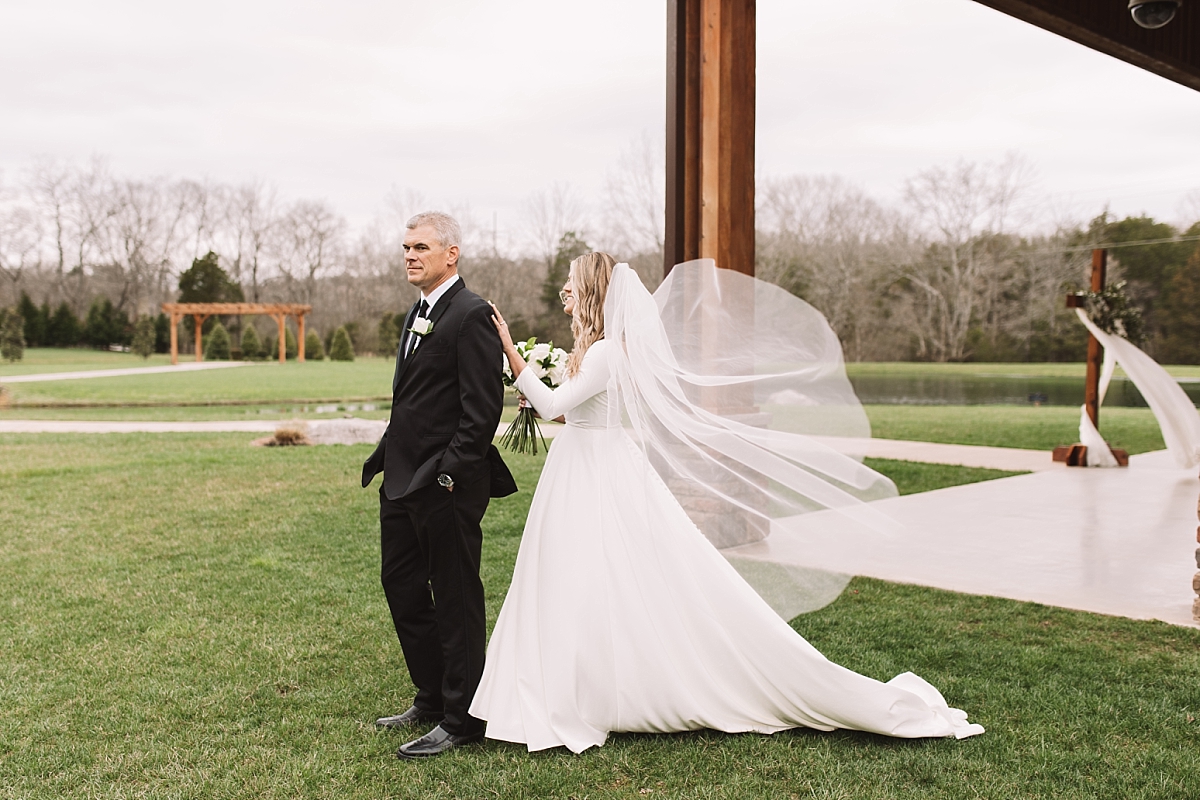 Bride tapping fathers shoulder for his first look of his daughter on her wedding day