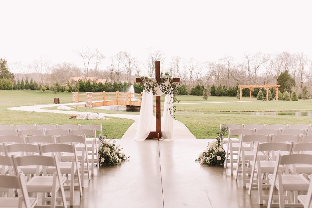 Wooden cross under the patio at The Barn at Sycamore Farms for outdoor covered ceremony