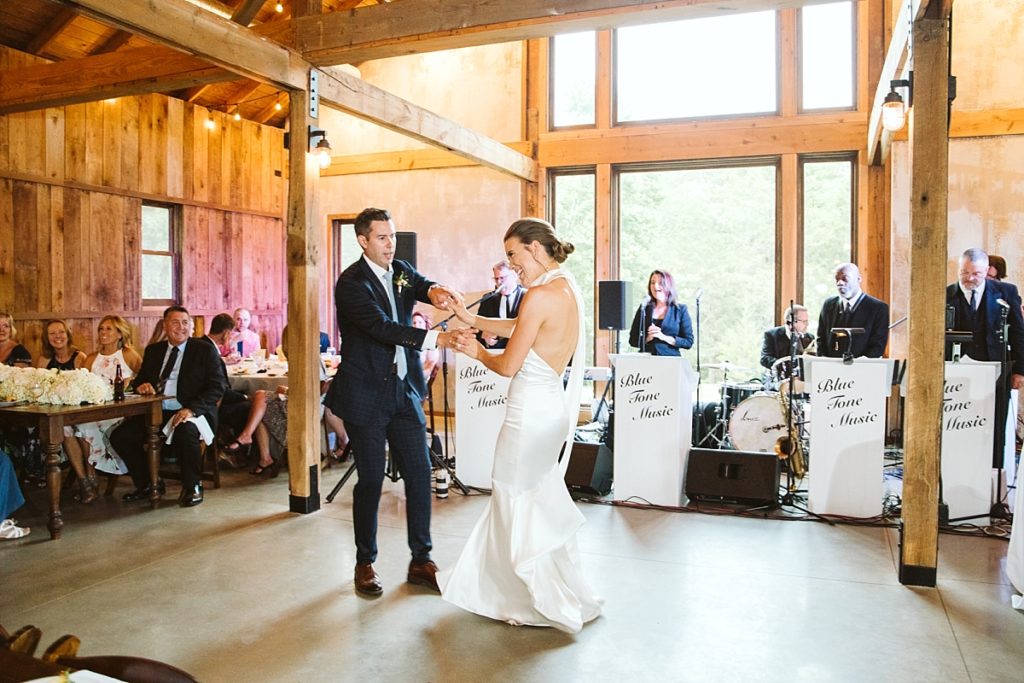 Bride and groom dancing to a live band inside of the barn at Cedarmont Farm
