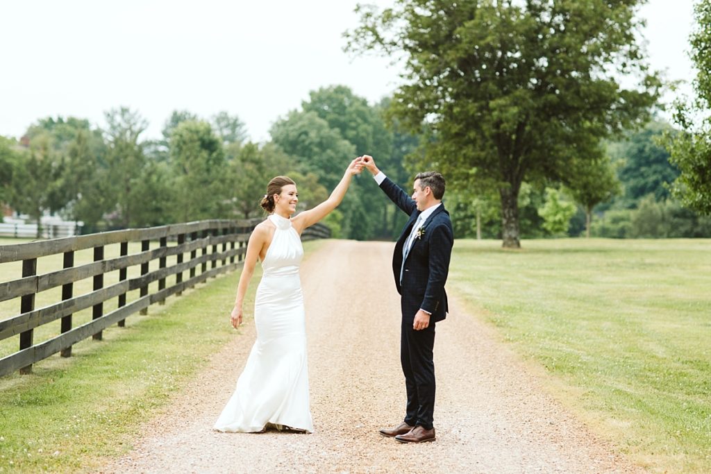 Couple dancing on a country road at Cedarmont Farm on their wedding day