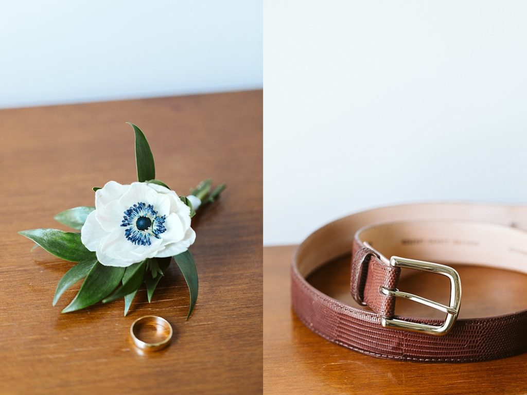 Detail photo of the grooms boutonniere, wedding ring and belt