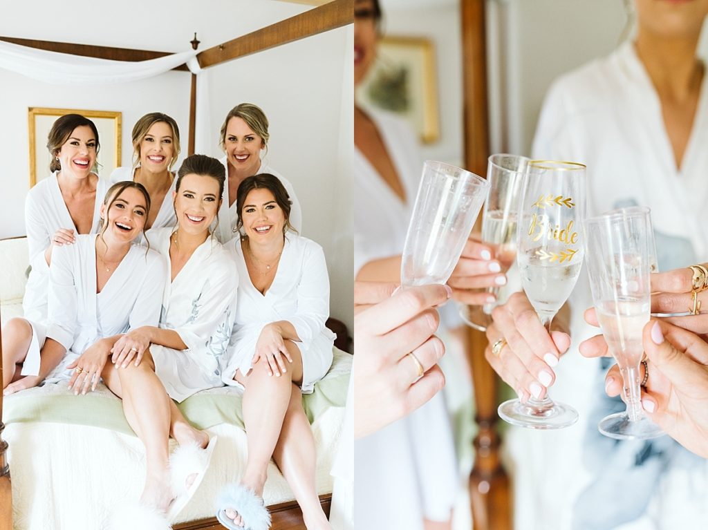 Bride with bridesmaid toasting in white robes
